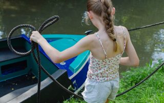 A child with a rope mooring up a Union Wharf Narrowboat