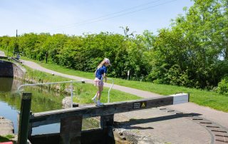 A young girl helping her family open the lock at Foxton Locks for her Union Wharf Narrowboats holiday