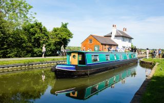 A Union Wharf Narrowboat for hire cruising through Foxton Locks