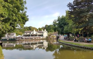 The scenery when cruising on the Foxton, Welford and Return 3-night route with Union Wharf narrowboat hire. A view of Foxton Locks and the Foxton Locks Inn from the basin of the canal.