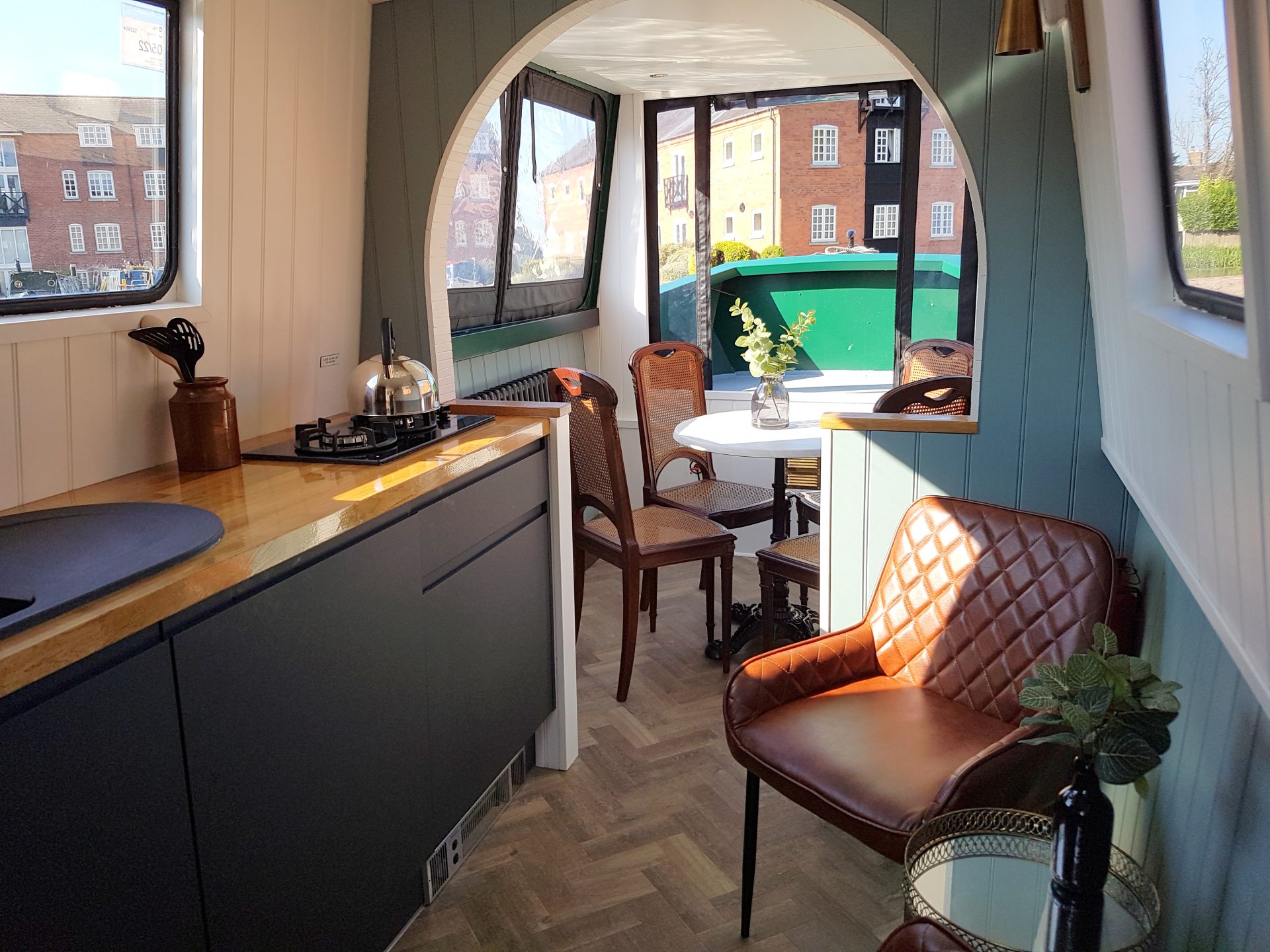 1-20210605_083017 Interior of a Union Wharf Narrowboats day boat for hire. A modern, boutique and stylish interior with a kitchenette, dining table, and views of the marina.